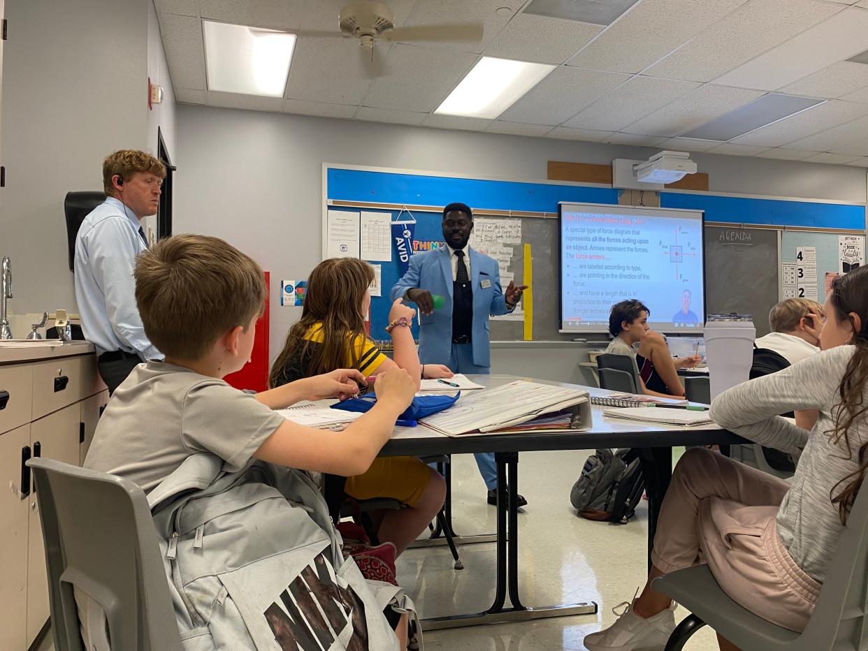 Christian Nakeli, from Cameroon, on Monday teaches about free body diagrams in sixth-grade science at Gentry Middle School.