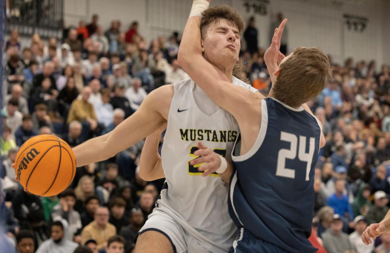 Marlboro Jack Seidler (No. 22) drives to the basket in first half action with Manasquan's Matt Solomon (No. 24) standing in the way. Marlboro Boys Basketball defeats Manasquan 63-46 in Shore Conference Finals in Toms River on February 27, 2022.