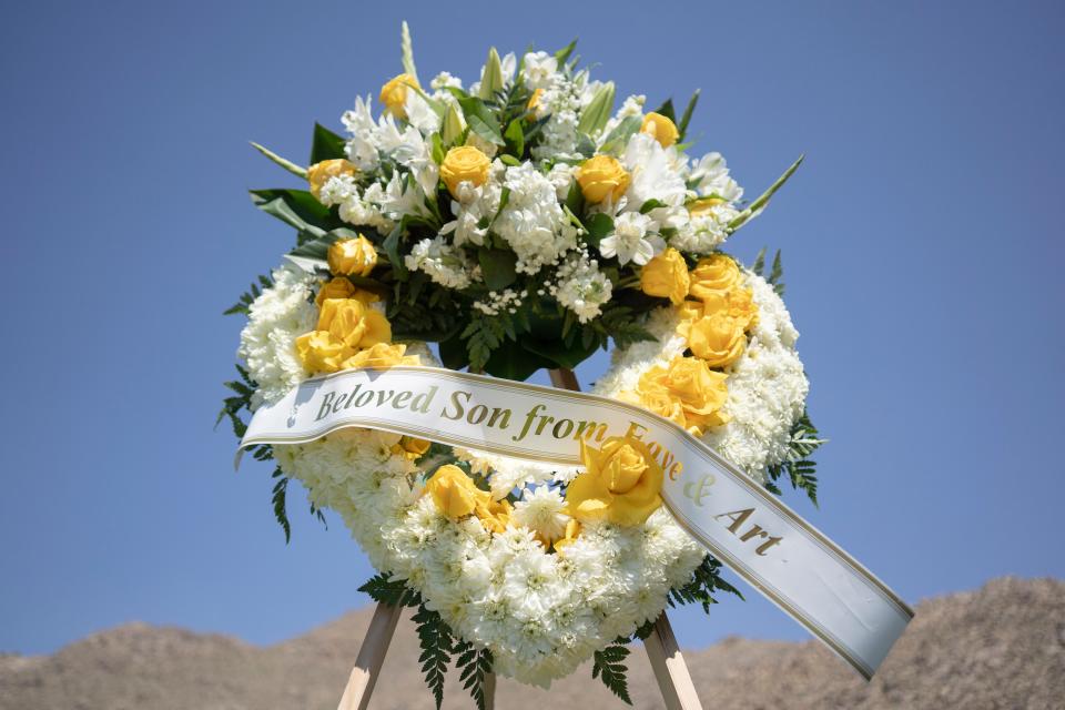 A wreath floral arrangement for Ryan Gainer is placed close to his gravesite during his burial on Saturday, April 20, 2024 at Sunset Hills Memorial Park in Apple Valley.
