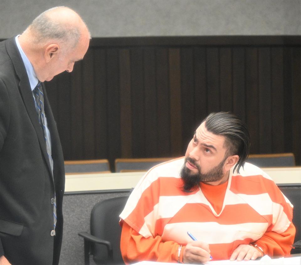 Public defender John Vincent confers with Adan Rodriguez at sentencing in November 2022.