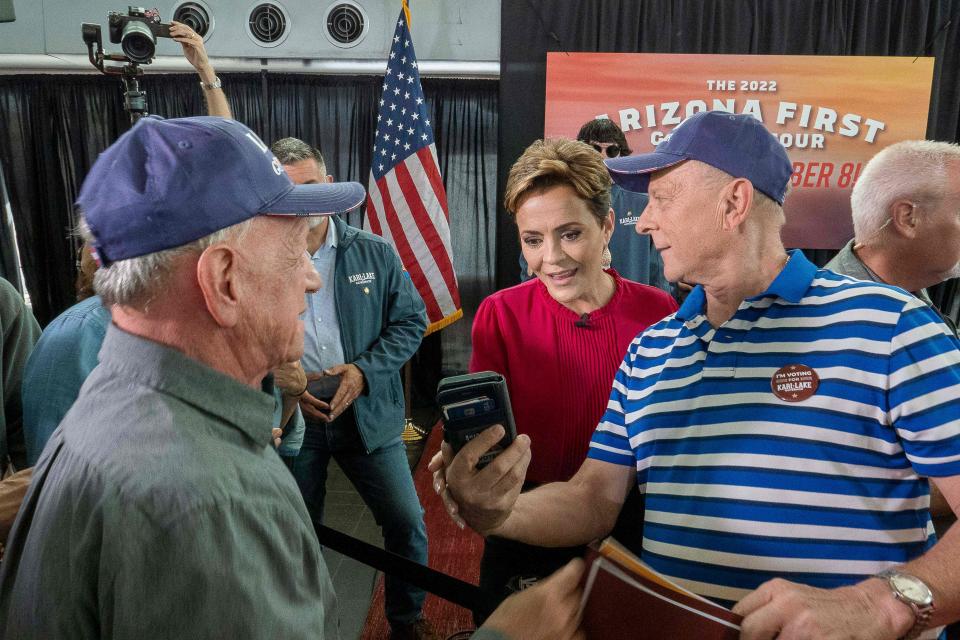 Republican nominee for governor of Arizona Kari Lake takes photos with supporters during a rally at Dream City Church in Phoenix, Arizona, on November 7, 2022 on the eve of the US midterm elections.