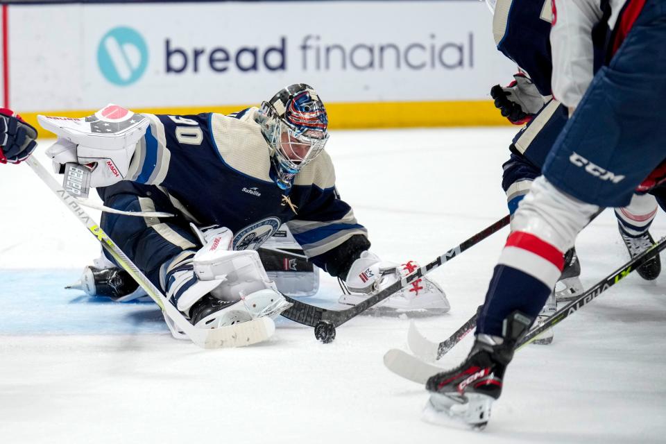 Jan 5, 2023; Columbus, Ohio, USA;  Columbus Blue Jackets goaltender Elvis Merzlikins (90) blocks a goal attempt by Washington Capitals center Aliaksei Protas (59) during the second period of the NHL game between the Columbus Blue Jackets and the Washington Capitals on Thursday night at Nationwide Arena. Mandatory Credit: Joseph Scheller-The Columbus Dispatch