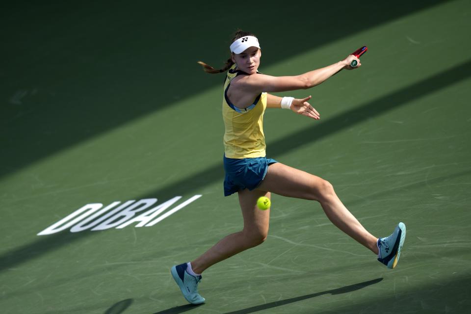 Elena Rybakina of Kazakhstan returns the ball to Victoria Azarenka during a match of the Dubai Duty Free Tennis Championships in Dubai, United Arab Emirates, Monday, Feb. 19, 2024. (AP Photo/Kamran Jebreili)