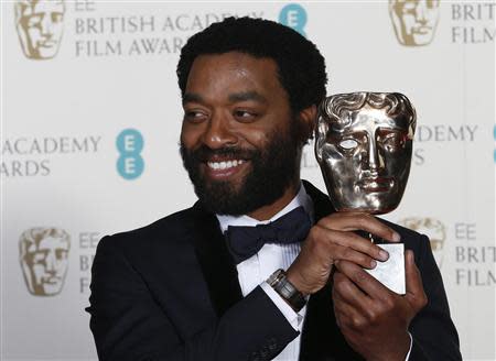 Actor Chiwetel Ejiofor celebrates after winning Best Actor for "12 Years a Slave" at the British Academy of Film and Arts (BAFTA) awards ceremony at the Royal Opera House in London February 16, 2014. REUTERS/Suzanne Plunkett