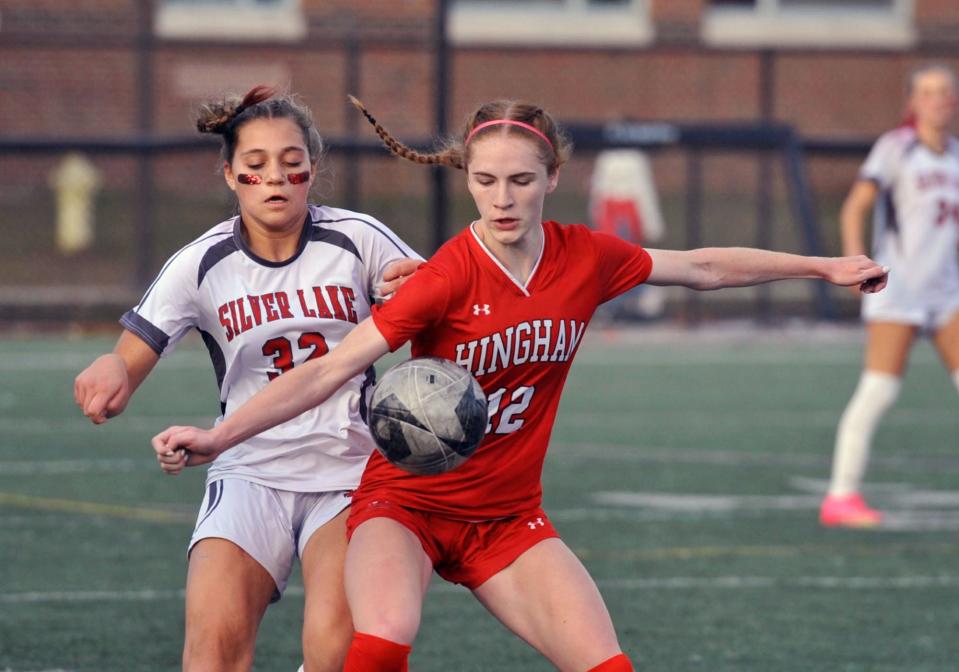 Hingham's Claire Murray, right, keeps Silver Lake's Kylie Madeiros, left, at bay as she controls the ball during the first round of the Div. 2 girls soccer state tournament at Hingham High School, Sunday, Nov. 5, 2023.