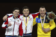 Nikita Nagornyy of Russia, center and gold medal, Artur Dalaloyan of Russia, left and silver medal, and Igor Radivilov of the Ukraine, right and bronze medal, celebrate during the award ceremony for the vault in the men's apparatus finals at the Gymnastics World Championships in Stuttgart, Germany, Sunday, Oct. 13, 2019. (AP Photo/Matthias Schrader)