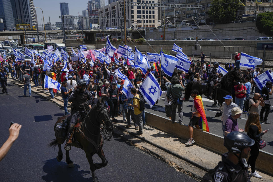 Israeli mounted police disperse demonstrators blocking a highway during a protest against plans by Prime Minister Benjamin Netanyahu's government to overhaul the judicial system in Tel Aviv, Israel, Thursday, May 4, 2023. (AP Photo/Ariel Schalit)