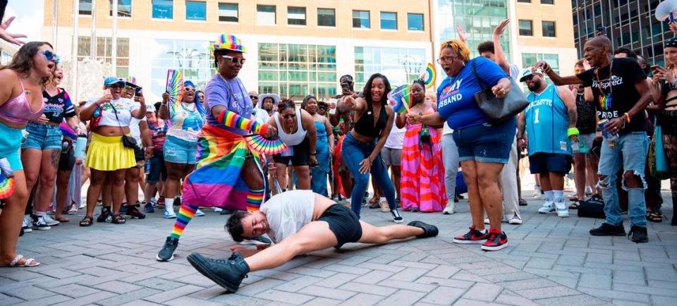 People cheer and fan Nick as he does a split in the middle of the dance circle near the main stage at Raleigh Pride on Saturday, June 22, 2024.