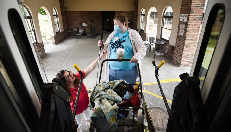 "All of the drivers are so kind, especially Molly," Andrea Ordiway, right, says, as Clinton Transit bus operator Molly Berger helps her board the "blue bus" following Ordiway's volunteer shift with senior citizens Wednesday, June 14, 2023, in Clinton County. Ordiway, who is legally blind relies on Clinton Transit for transportation. "She's always happy and she's become a friend," Ordiway says of Berger.