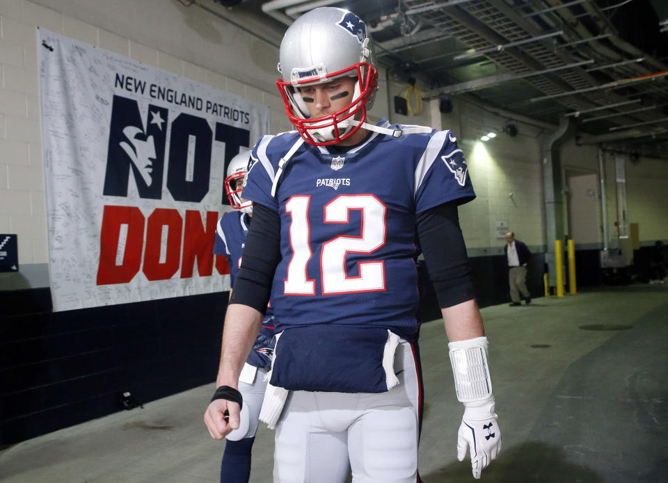 New England Patriots quarterback Tom Brady walks toward the field to warm up before the AFC championship against the Jacksonville Jaguars, Sunday. (AP)