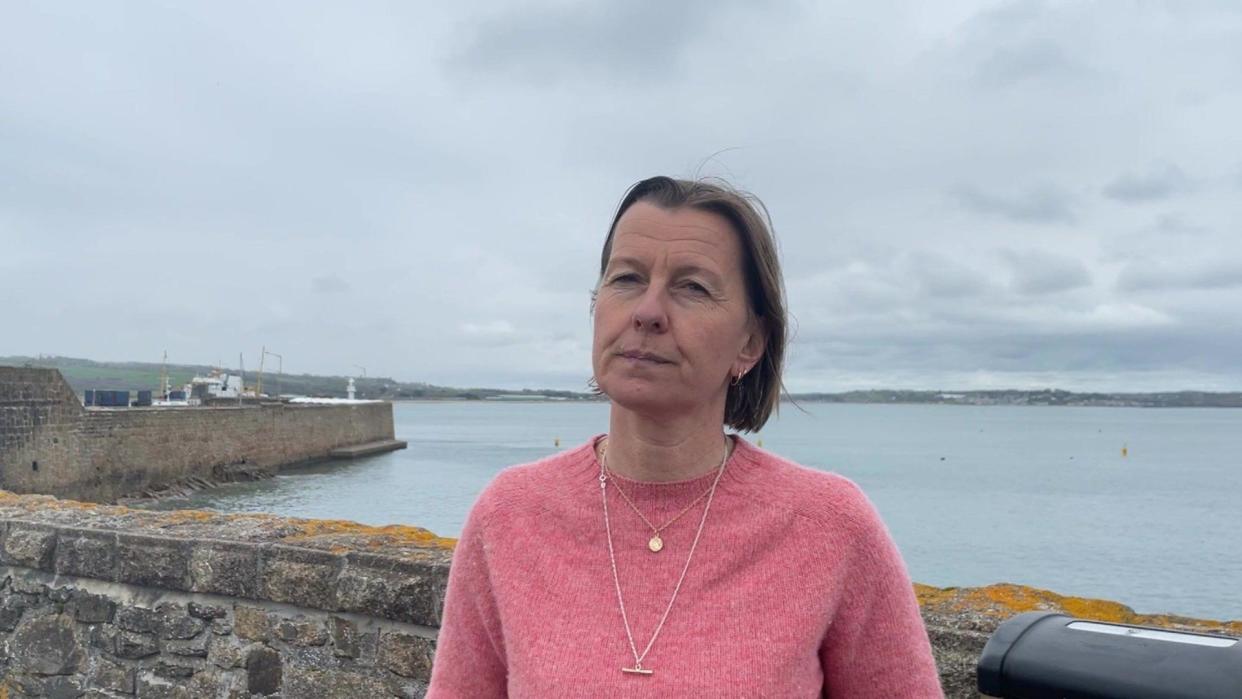 Woman standing by pier