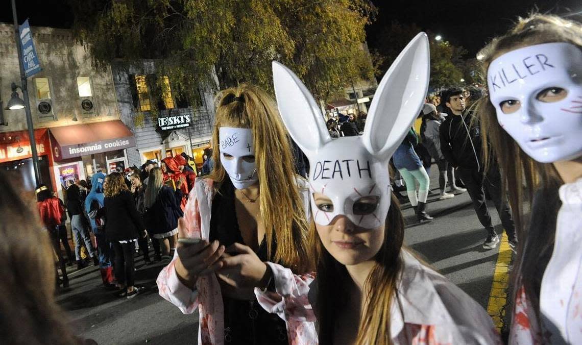 Girls dressed like in the movie “The Purge” parade on Franklin Street Tuesday night during the annual Homegrown Halloween. Police estimated 15,000 people turned out for the event, one of the smallest crowds for the All Hallow’ Eve tradition.