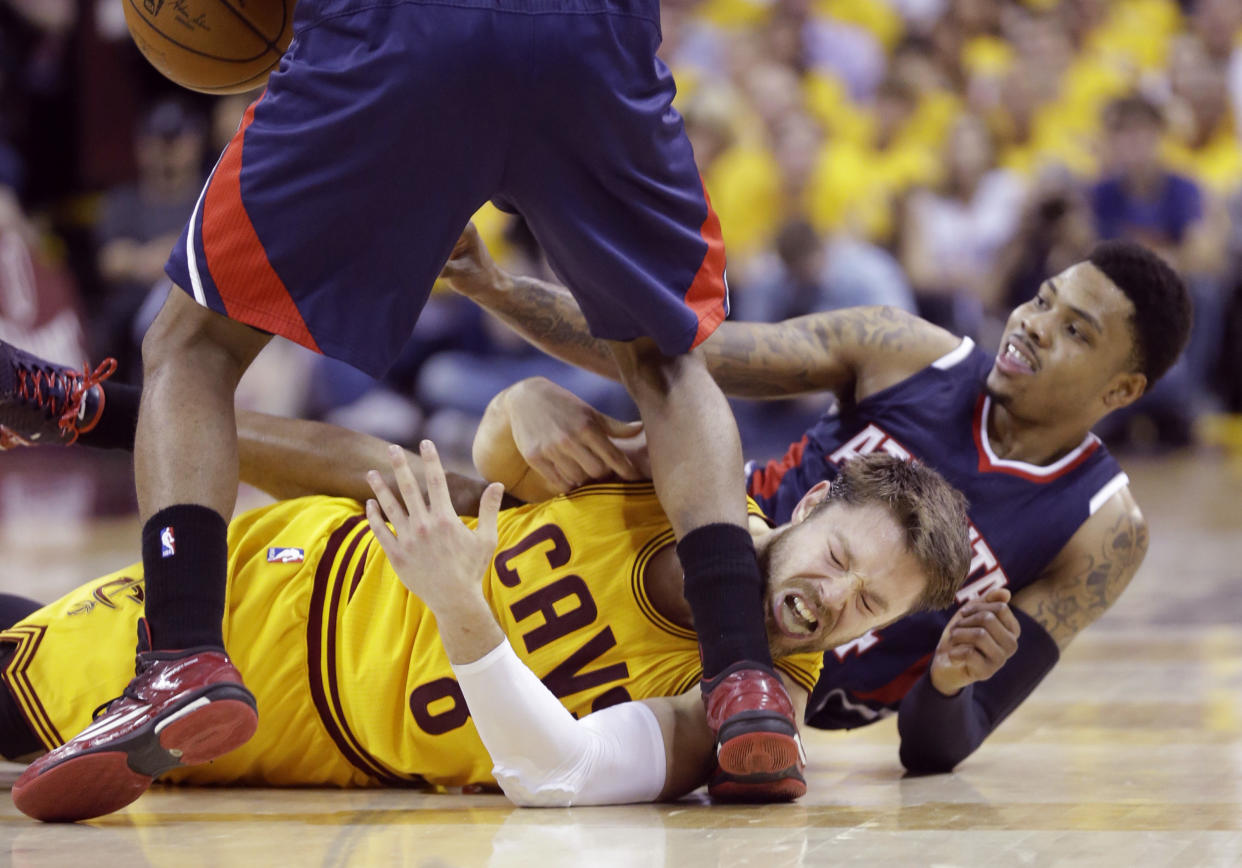 Cleveland Cavaliers&#39; Matthew Dellavedova, front, tangles with Atlanta Hawks&#39; Kent Bazemore during the second half in Game 3 of the Eastern Conference finals of the NBA basketball playoffs Sunday, May 24, 2015, in Cleveland. (AP Photo/Tony Dejak)