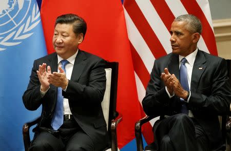 U.S. President Barack Obama and Chinese President Xi Jinping clap as UN Secretary General Ban Ki-moon (not pictured) delivers his speech during a joint ratification of the Paris climate change agreement ahead of the G20 Summit at the West Lake State Guest House in Hangzhou, China, September 3, 2016. REUTERS/How Hwee Young/Pool