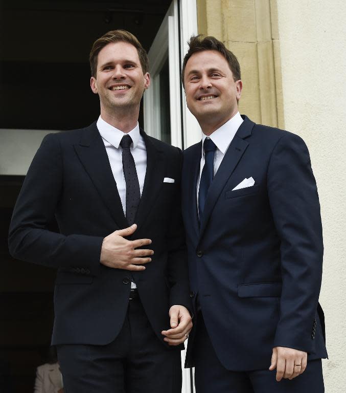 Luxembourg Prime Minister Xavier Bettel (R) and his partner Gauthier Destenay pose outside City Hall during their wedding in Luxembourg on May 15, 2015