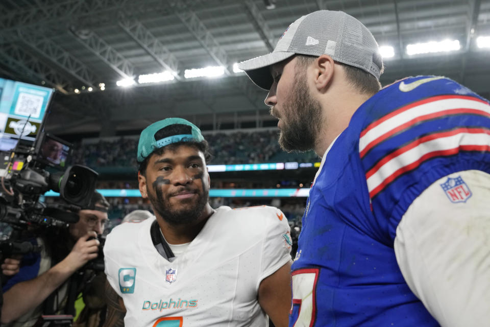 Miami Dolphins quarterback Tua Tagovailoa and Buffalo Bills quarterback Josh Allen talk at the end of an NFL football game, Sunday, Jan. 7, 2024, in Miami Gardens, Fla. The Bills defeated the Dolphins 21-14. (AP Photo/Lynne Sladky)