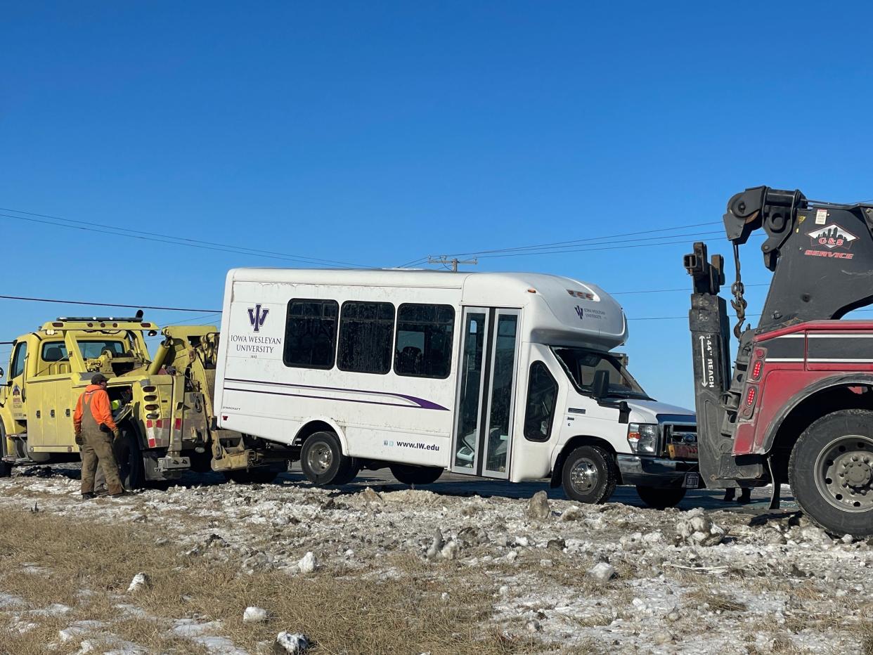 An Iowa Wesleyan University bus is towed from Iowa Highway 163 in Polk County on Wednesday, Feb. 1, 2023. It had been enroute to Des Moines when it flipped on its side, the Polk County Sheriff's Office said. Some of the passengers suffered minor injuries.