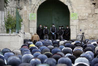 Israeli Police officers wear protective face masks as Muslim worshippers offer Eid al-Fitr prayers marking the end of the holy fasting month of Ramadan outside the al-Aqsa mosque compound, which remains shut to prevent the spread of coronavirus, in Jerusalem, Sunday, May 24, 2020. (AP Photo/Mahmoud Illean)