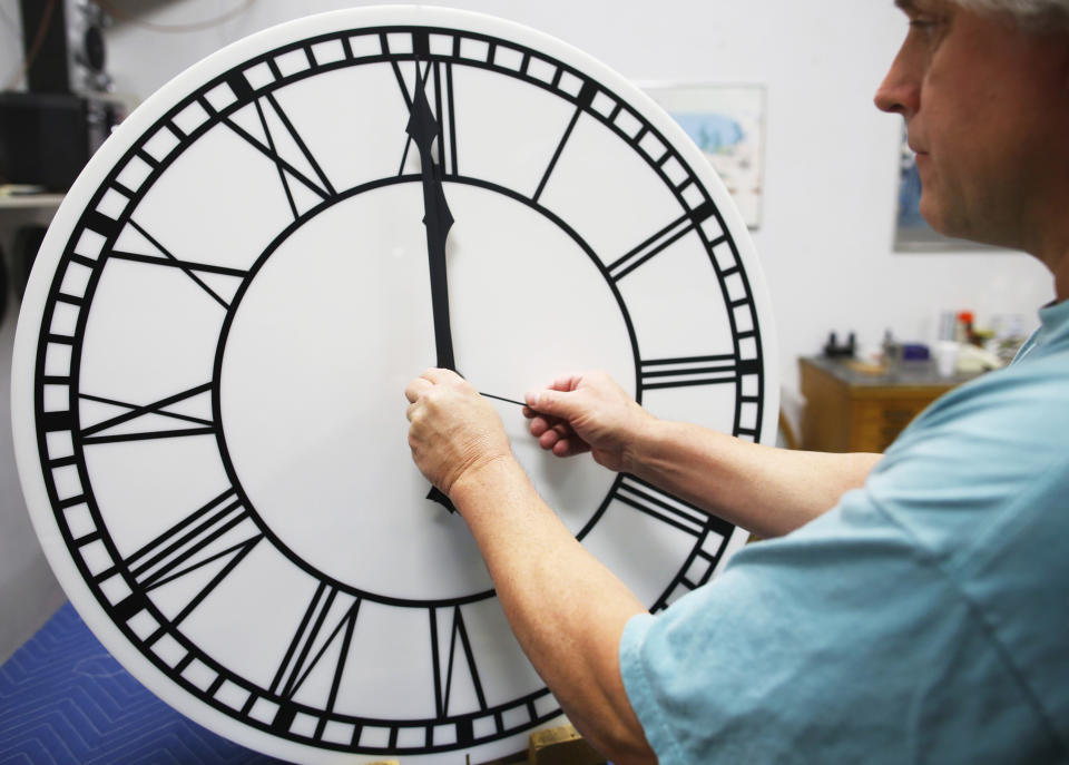 Scott Gow assembles a clock dial for a four-dial street clock headed to the Lincoln Haymarket Historic District in Nebraska at the Electric Time Company in Medfield, Massachusetts November 1, 2013. REUTERS/Brian Snyder 