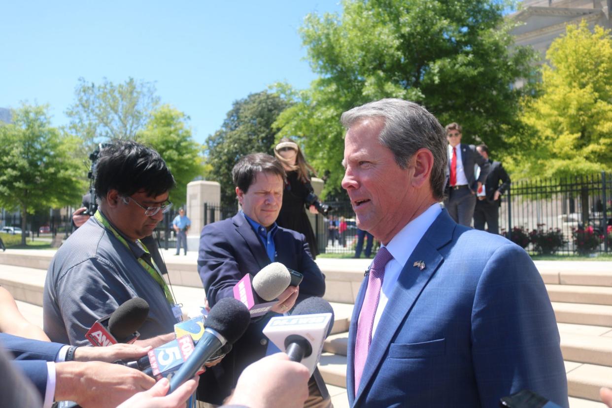 Georgia Gov. Brian Kemp speaks to the press after a bill signing ceremony outside the state capitol.