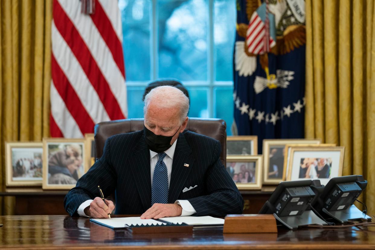 President Joe Biden signs an Executive Order reversing the Trump-era ban on transgender individuals serving in the military in the Oval Office of the White House on Monday, Jan. 25, 2021, in Washington.