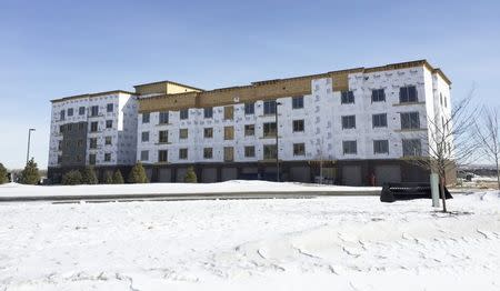 Construction continues on an apartment building in Williston, North Dakota, set to contain a swimming pool and other amenities February 27, 2015. REUTERS/Ernest Scheyder