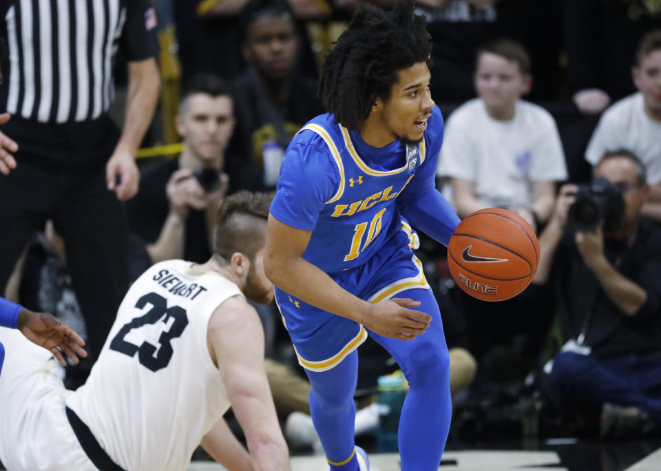 UCLA guard Tyger Campbell, right, picks up the ball after it was turned over by Colorado forward Lucas Siewert in the first half of an NCAA college basketball game Saturday, Feb. 22, 2020, in Boulder, Colo. (AP Photo/David Zalubowski)