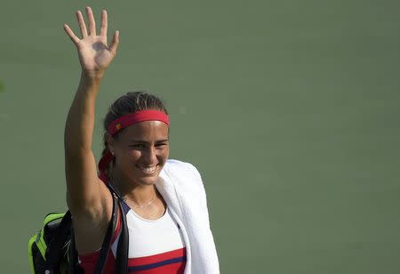 2016 Rio Olympics - Tennis - Preliminary - Women's Singles Third Round - Olympic Tennis Centre - Rio de Janeiro, Brazil - 09/08/2016. Monica Puig (PUR) of Puerto Rico celebrates after winning her match against Garbine Muguruza (ESP) of Spain. REUTERS/Toby Melville