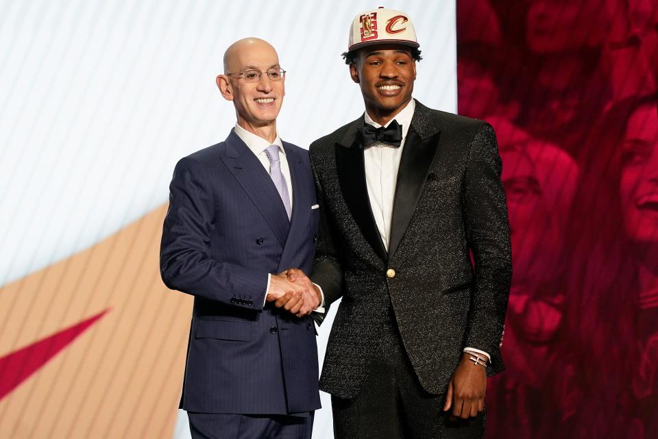 Ochai Agbaji is congratulated by NBA Commissioner Adam Silver after being selected 14th overall by the Cavaliers in the NBA Draft on Thursday in New York. [John Minchillo/Associated Press]