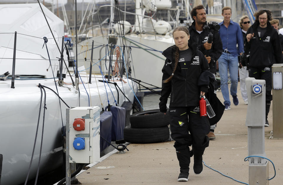 Climate change activist Greta Thunberg arrives to board the Malizia II boat in Plymouth, England, Wednesday, Aug. 14, 2019. The 16-year-old climate change activist who has inspired student protests around the world will leave Plymouth, England, bound for New York in a high-tech but low-comfort sailboat.(AP Photo/Kirsty Wigglesworth, pool)