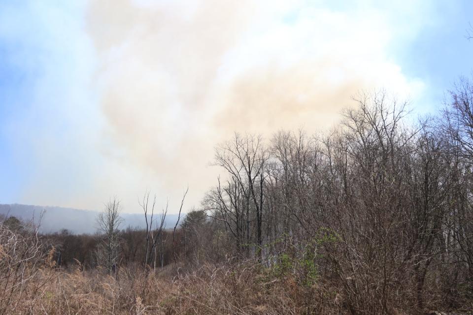 First responders including the NJ Forest Fire Service and local teams battle a forest fire in the mountains of West Milford, NJ on April 13, 2023.
