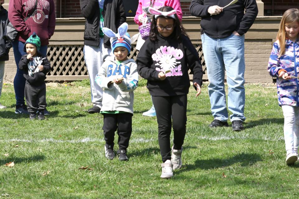 Gabe Turner, 5, along with his sister, Olivia, 8, of Sandusky, carefully carry their eggs at the annual Hayes Easter Egg Roll at Spiegel Grove on Saturday.