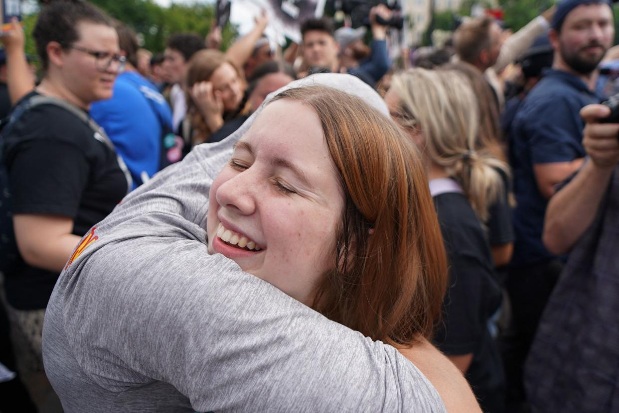 Two people hug as they celebrate the Supreme Court decision overturning Roe v. Wade.