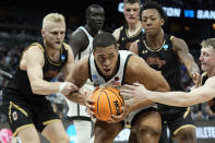 San Diego State forward Jaedon LeDee (13) is surrounded by Charleston guard Dalton Bolon (3), forward Raekwon Horton (5), and guard Ryan Larson (11) during the first half of a first-round college basketball game in the NCAA Tournament Thursday, March 16, 2023, in Orlando, Fla. (AP Photo/Chris O'Meara)