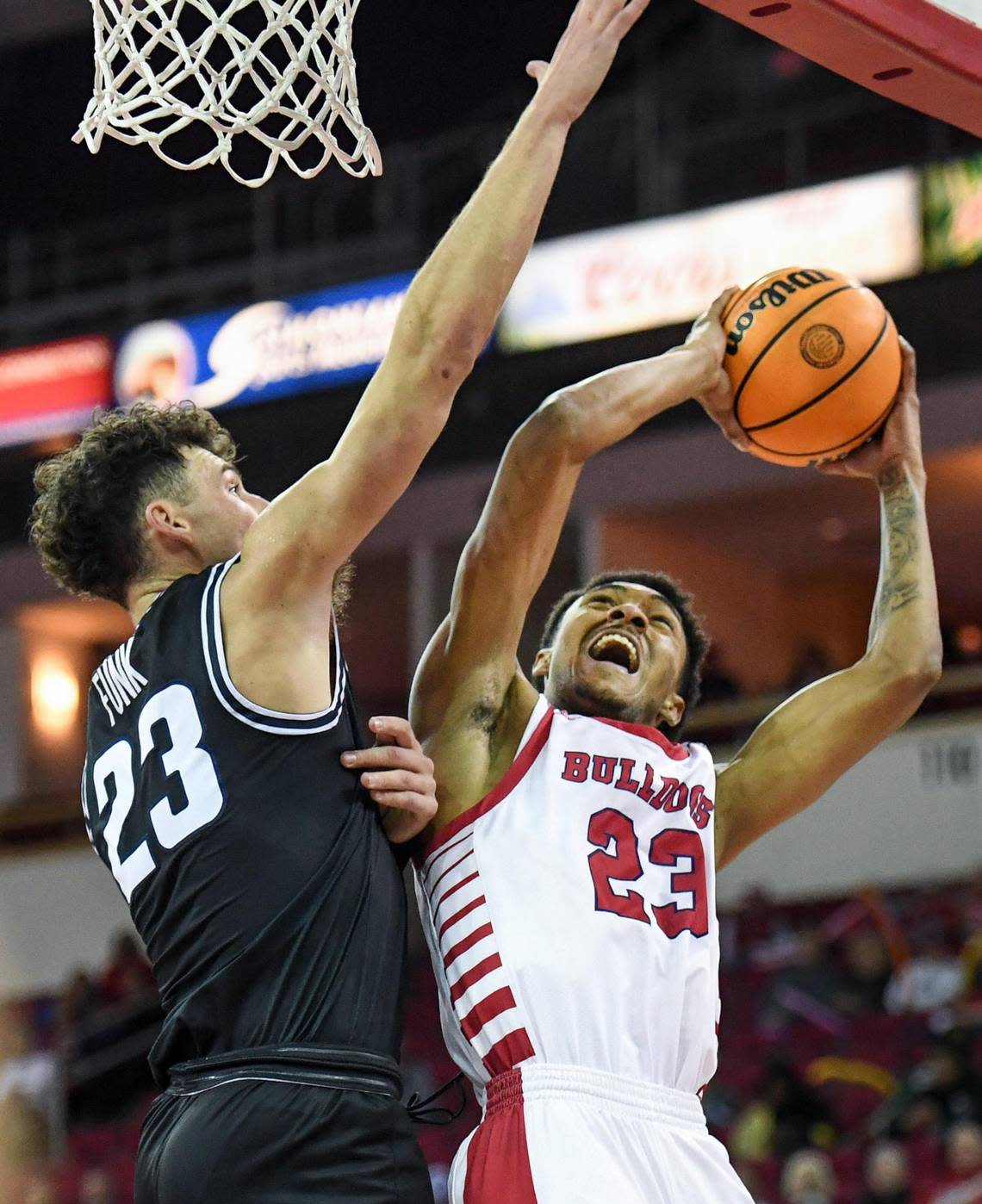 Fresno State’s Leo Colimerio, right, tries to to to the hoop but runs into defense from Utah State’s Taylor Funk during their Mountain West Conference game at the Save Mart Center in Fresno on Saturday, Jan. 28, 2023.