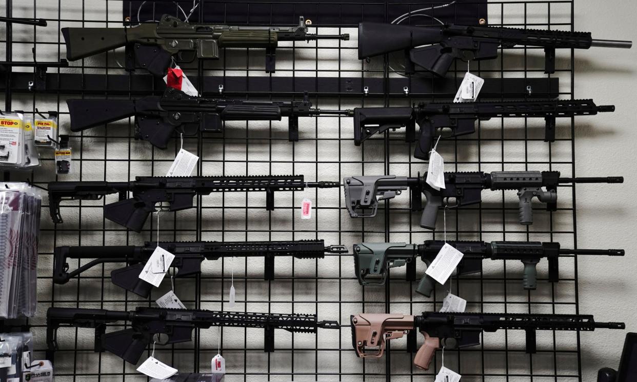 <span>AR-15 style rifles are displayed for sale at Firearms Unknown, a gun store in Oceanside, California, in 2021.</span><span>Photograph: Bing Guan/Reuters</span>