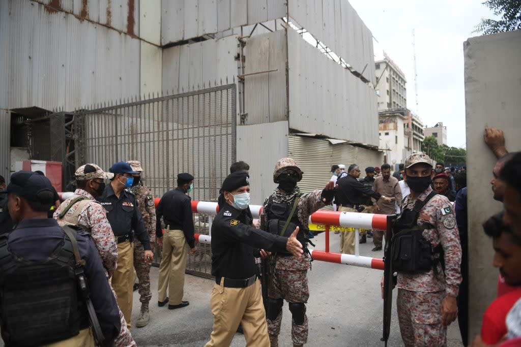 Security personnel stand guard outside the Pakistan Stock Exchange building following attack by gunmen: Getty Images