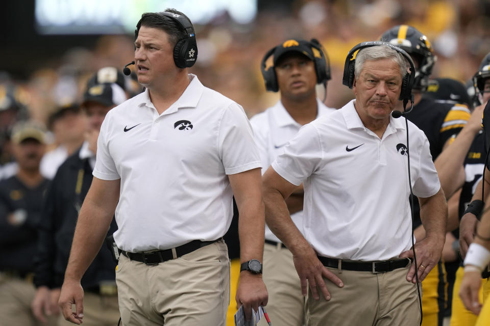Iowa offensive coordinator Brian Ferentz (left) and head coach Kirk Ferentz are still searching for answers on offense this season. (AP Photo/Charlie Neibergall)