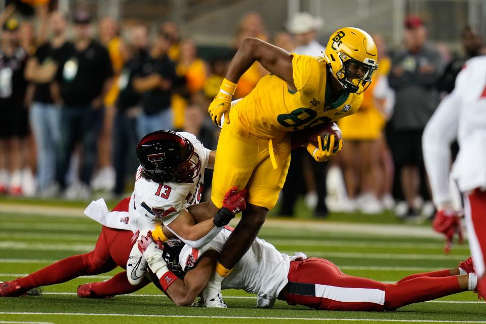 Baylor tight end Drake Dabney (89) makes a catch as Texas Tech linebacker Ben Roberts (13) defends during the Big 12 football game, Saturday, Oct. 7, 2023, at McLane Stadium in Waco, Texas.