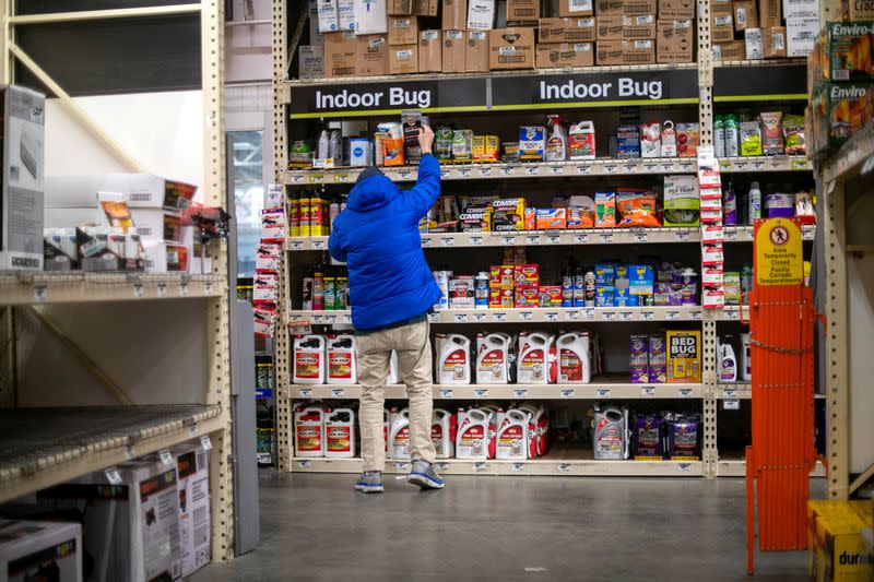 FILE PHOTO: A shopper reaches for merchandise at a Home Depot store in Wilmington