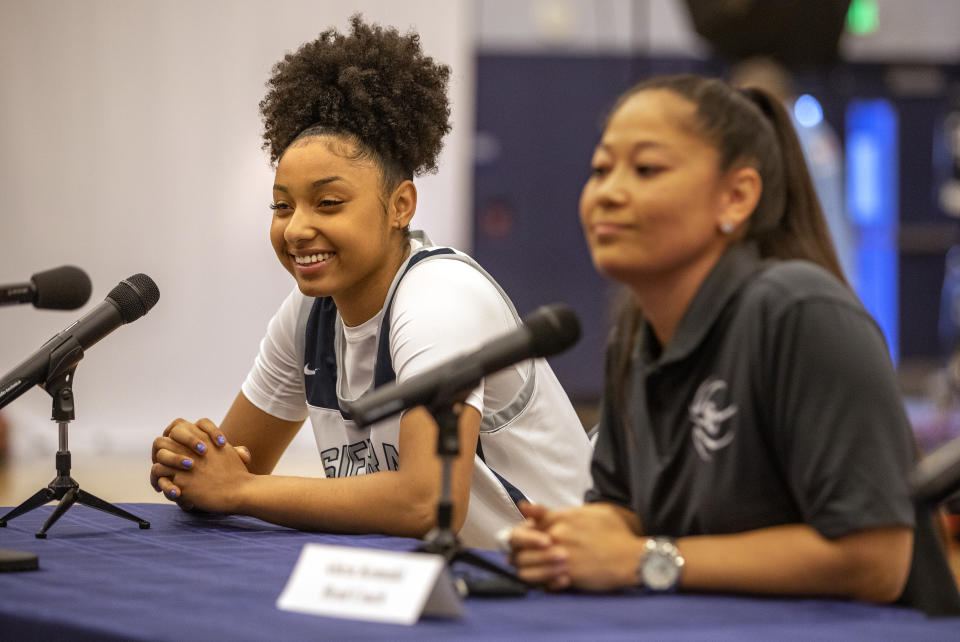 CHATSWORTH, CA - OCTOBER 27, 2021: JuJu Watkins, left, a member of the Sierra High School girls basketball team, and head coach Alicia Komaki take questions from reporters during media day inside the schools gymnasium.  (Mel Melcon / Los Angeles Times via Getty Images)