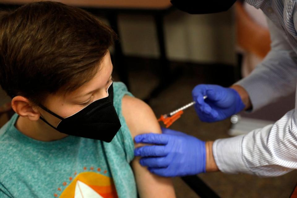 A child receives the Pfizer-BioNTech Covid-19 Vaccine from a pharmacist in Bloomfield Hills, Michigan (File photo) (AFP via Getty Images)