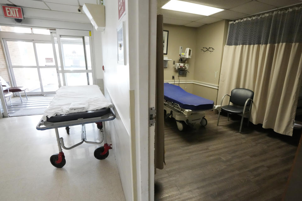 An unused gurney rests in the emergency room hallway outside one of the treatment rooms at the Alliance Healthcare System hospital in Holly Springs, Miss., Feb. 29, 2024. Rural emergency hospitals are starting to gain a small foothold in the United States. They provide 24/7 emergency care and receive more than $3 million in federal money a year. But the catch is there are zero inpatient beds at the facilities. (AP Photo/Rogelio V. Solis)