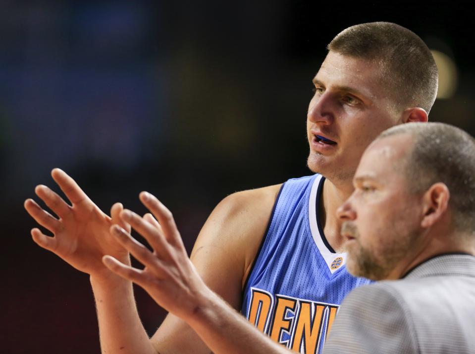 Nikola Jokic describes how he sees the celebration going. Mike Malone is not so sure. (AP)