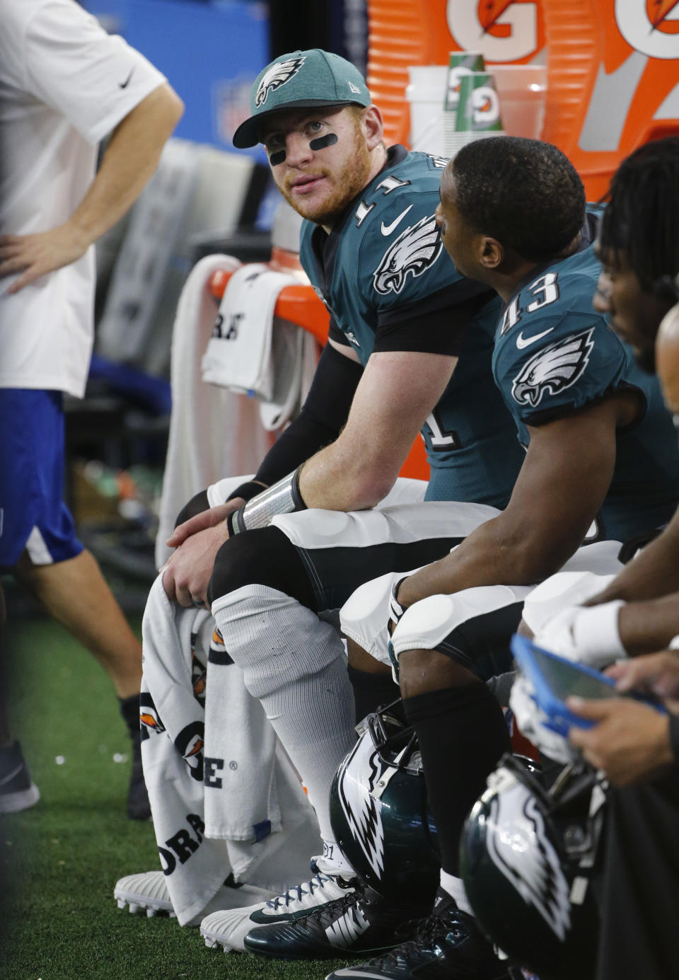 Philadelphia Eagles quarterback Carson Wentz (11) sits on the bench during the first half of an NFL football game against the Dallas Cowboys, in Arlington, Texas, Sunday, Dec. 9, 2018. (AP Photo/Michael Ainsworth)