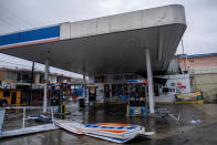 <p>A gas station sign damaged by Hurricane Fiona lies on the ground in Yauco, Puerto Rico September 18, 2022. REUTERS/Ricardo Arduengo</p> 