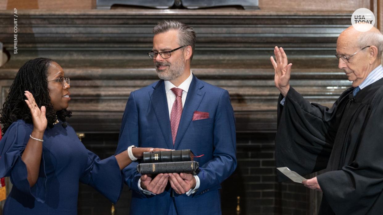 In this image from video provided by the Supreme Court, Chief Justice of the United States John Roberts administers the Constitutional Oath to Ketanji Brown Jackson as her husband Patrick Jackson holds the Bible at the Supreme Court in Washington, Thursday, June 30, 2022. (Supreme Court via AP)