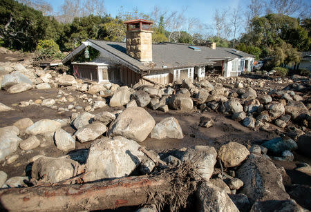 Boulders surround a mud-filled property after a mudslide in Montecito, California, U.S. January 12, 2018. REUTERS/ Kyle Grillot