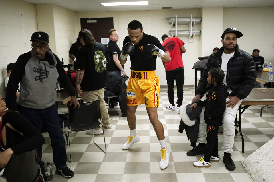 Gordie Russ II of Detroit loosens up during a Detroit Brawl boxing event, Saturday, March 5, 2022, in Dearborn, Mich. By the time Thomas "The Hitman" Hearns was done throwing his feared right hand in 2006, the city had taken so many blows over the decades that its population was knocked down and out of the country's top 20 towns. These days, the city and the sport are fighting to get up off the mat. But boxing is still here, if at a smaller scale. (AP Photo/Carlos Osorio)