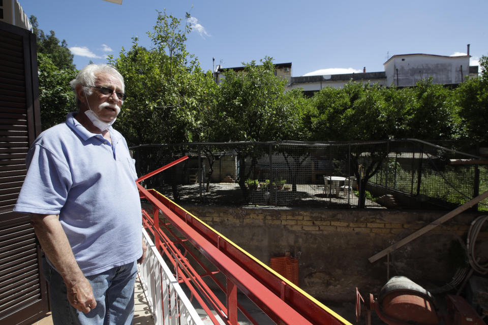 Marvin Hewson, from the United States, poses for a photograph on a balcony overlooking lemon trees before leaving the apartment where he and his wife Colleen stayed in Pompeii, near Naples, southern Italy, Tuesday, May 26, 2020. An American couple waited a lifetime plus 2 ½ months to visit the ancient ruins of Pompeii together. For Colleen and Marvin Hewson, the visit to the ruins of an ancient city destroyed in A.D. 79 by a volcanic eruption was meant to be the highlight a trip to celebrate his 75th birthday and their 30th anniversary. They were among the only tourists present when the archaeological site reopened to the public on Tuesday after the national lockdown to prevent the spread of COVID-19. (AP Photo/Alessandra Tarantino)